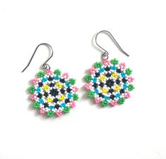 Celebrate summer with these beautiful hand-woven earrings. With a playful pattern of hand-woven beads in summery shades, these earrings convey a cheerful and energetic appearance. A perfect choice for a stylish touch on warm days. The silver-colored ear hooks are made of stainless steel/stainless steel (durable, hypo-allergenic, of high quality and do not discolour). It is also possible to opt for gold-colored earrings. The pendant has a diameter of approximately 3.5 cm (1.38") 🔴 Tips for jewel Multicolor Flower Earrings For Summer Beach, Fun Multicolor Earrings For Summer, Fun Multicolor Summer Earrings, Summer Multicolor Flower Earrings, Handmade Rainbow Earrings For Summer, Handmade Multicolor Playful Beaded Earrings, Playful Handmade Multicolor Beaded Earrings, Playful Multicolor Handmade Beaded Earrings, Playful Handmade Multicolor Flower Earrings