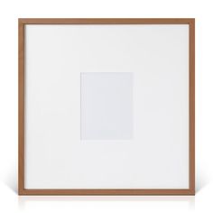 a white square in a wooden frame on a white surface with a light brown border