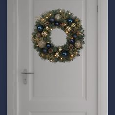 a christmas wreath hanging on the front door