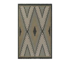 a beige and black rug with an abstract design on the bottom, in front of a white background