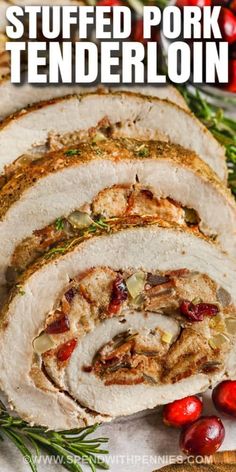 sliced pork tenderloin on a cutting board with cranberries