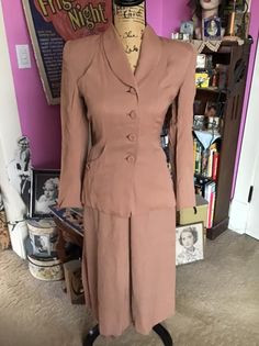 "Vintage 1940's 1950's two piece ladies suit. Feels like a Gab blend. Has large shoulder pads, 2 pockets at the hips and 2 slip pockets by the bust. Left side metal zipper with a button on the skirt. Jacket is full lined. No issues with the lining. No seam allowances or stretch to the fabric. The button on the skirts waist could be moved over about 2\" for more room. The color of the suit shows best in the first picture. This is a small size suit. PLEASE go by the measurements I provide below. * 1950s Suit, Extra Dress, 1940s Women, Suits Show, Pop Stitch, Vintage Clothing Boutique, Ladies Suit, Womens Suits, Vintage Suits