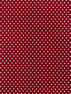 a red and white polka dot fabric with small white dots on the bottom of it