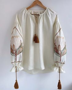 Graceful, soft linen blouse with an embroidered protea flower. Hygge is coziness, inner and outer comfort, harmony of body and mind... Our designers really liked the Scandinavian philosophy of hygge. It is easy to create an atmosphere of comfort and beauty from the simple things around us. The ability to create comfort and beauty from natural materials has always been part of the ancient Slavic tradition, part of our DNA. This luxurious natural linen blouse will immerse you in an atmosphere of p Protea Flower, Design Blouse, Womens Blouses, Women's Blouses, Linen Blouse, Simple Things, Linen Women, Embroidered Blouse, Natural Linen