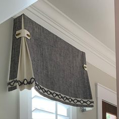 a window with a curtain hanging from it's side