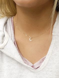 Dainty crescent moon choker necklace, perfect for layering. A dainty crescent moon charm measuring hangs from a delicate but sturdy 16 inch 14k gold filled chain. If you would prefer this necklace shorter or longer, we can make this from 14-18 inches. Just remind me in the notes to seller section. I also offer this in sterling silver Details Gold option; Gold plated crescent moon charm measuring 12mm x 17mm 14 k gold filled chain Arrives in a gift box Silver option: Sterling silver chain Rhodium Minimalist Crescent Charm Necklace With Clavicle Chain, Minimalist Crescent Clavicle Chain Charm Necklace, Delicate Crescent Moon Charm Necklace, Dainty Crescent Moon Charm Necklace, Dainty Crescent Jewelry With Delicate Chain, Dainty Crescent-shaped Jewelry With Delicate Chain, Delicate Half Moon Necklace With Moon Phase Detail, Delicate Half Moon Necklace With Moon Phase, Delicate Half Moon Phase Necklace