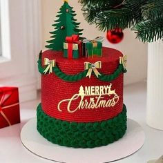 a red and green christmas cake sitting on top of a white plate