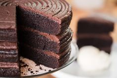 a chocolate cake is cut into pieces on a plate