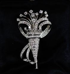 "Absolutely stunning Art Deco era 18 carat white gold and 124 excellent quality diamonds Tremblant brooch! The bouquet diamonds are set in an articulated \"tremblant\" setting. The brooch comes in its original fitted leather and velvet case. Measurements: 2 diamonds diameter 3mm (0,11\") 8 diamonds diameter 2,25mm (0,08\") 4 diamonds diameter 2mm (0,07\") 108 diamonds diameter 1,5mm (0,05\") Total carat weight is approximately 1.72 carats approximate width 3,5cm (1,37\") Approximate height 5,5cm Formal Diamond White Brilliant Cut Brooch, Diamond Brooches In Brilliant Cut White Gold, White Gold Diamond Brooch With Brilliant Cut, Diamond White Brooch With Diamond Accents, Formal Single Cut Diamond Brooch, Anniversary Brooches With Single Cut Diamonds In Diamond White, Diamond Brilliant Cut Brooch For Anniversary, Diamond Brilliant Cut Brooches For Anniversary, Brilliant Cut Diamond Brooch For Anniversary