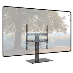 a flat screen tv sitting on top of a metal stand next to a large tree