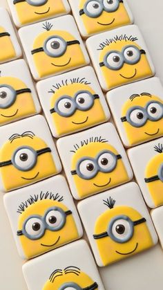 some yellow and black minion magnets with eyes on them are arranged in rows