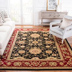 a living room with white couches and rugs