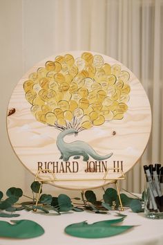 there is a sign that says richard john 11 on the table with green leaves around it