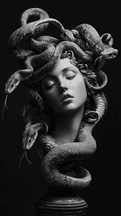 a black and white photo of a woman's head with snakes on her head