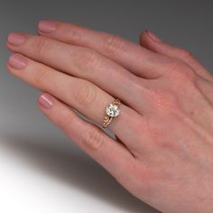 a woman's hand with a diamond ring on it