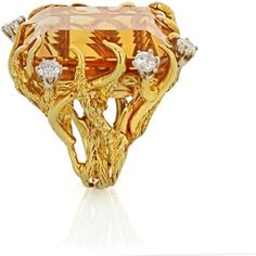 Transport yourself back to the glamorous era of the 1970s with our exquisite 18K Yellow Gold Citrine and Diamond Ring. This stunning piece captures the essence of the time, exuding elegance and sophistication.At the heart of this ring is a breathtaking 117-carat citrine, radiating warmth and capturing the golden hues of the sun. The vibrant gemstone is beautifully complemented by approximately 2 carats of dazzling diamonds, which dance and sparkle with every movement. The diamonds frame the citr Citrine Rings, Diamond Frame, Coral Ring, Yellow Gold Setting, Citrine Ring, Color Ring, Diamond Design, The 1970s, Brilliant Diamond