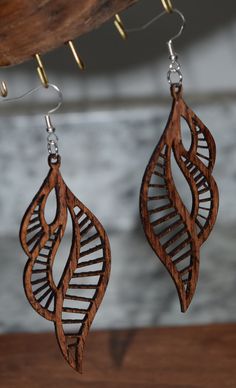 Wooden earring, unique, uncommon and stylish earrings very light weight with hypoallergenic stainless-steel hooks.  Shaped like a sea shell Handmade Spiral Earrings For Beach, Unique Spiral Ear Wire Earrings, Leaf-shaped Brown Earrings Gift, Unique Leaf-shaped Earrings For Gift, Brown Leaf-shaped Earrings Gift, Brown Leaf-shaped Earrings For Gift, Dangle Earrings As A Gift With Unique Design, Unique Design Dangle Earrings As Gift, Brown Teardrop Earrings For The Beach