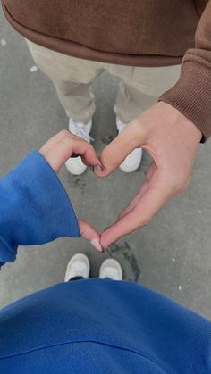 two people making a heart with their hands