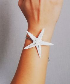 A dainty bridal starfish bracelet. Perfect for summer nautical style. Features the minimalist style with white natural real starfish. ❤S H I P P I N G ❥Shipping to the USA Standart shipping 7-12 business days Express shipping 3-4 business days ❥Shipping internationally Standart shipping 20-30 business days Express shipping 3-4 business days ❤A T T E N T I O N *INTERNATIONAL orders: PLEASE NOTE CUSTOMERS ARE RESPONSIBLE FOR ALL DUTIES & TAXES* White Star-shaped Ocean-inspired Jewelry, Ocean-inspired White Star-shaped Jewelry, Ocean-inspired White Star Jewelry, White Star-shaped Jewelry With Starfish Charm, Handmade White Starfish Bracelets, White Starfish Bracelet With Ocean-inspired Style, White Starfish Charm Bracelet, White Starfish Pendant Ocean-inspired Jewelry, White Ocean-inspired Starfish Bracelets