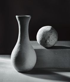 two white vases sitting next to each other on a table