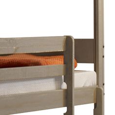 a wooden bunk bed with orange pillows on it