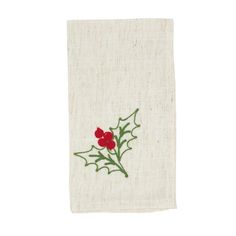 a white towel with red flowers and green leaves on the front, embroidered onto it