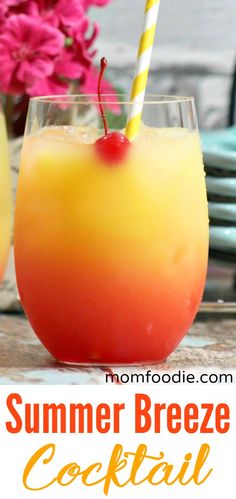 an orange and yellow drink in a glass with a straw next to it on a table