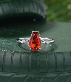 an orange stone ring sitting on top of a green tire