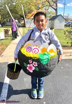 a young boy is holding an easter basket