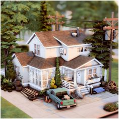 a large white house sitting on top of a lush green field next to a forest