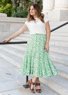 Mikayla is 5'5" and wearing a size small - Runs TTS - Elastic waistband for a comfortable fit - Beautiful true green floral print on a cream background - Tiered skirt for extra flow - Not see-through - Available in two colorways Product Measurements*Measurements are taken from side seam to side seamwhile laying flat. Small: Length: 34" Waist: 12" Medium: Length: 34" Waist: 13" Large: Length: 34.5" Waist: 14" Material and CareSelf: 100% Polyester Hand Wash in Cold Water Separately. Do Not Bleach. Green Flowy Skirt For Spring, Spring Green Skirt With Elastic Waistband, Green Skirt With Elastic Waistband For Spring, Green Floral Print Flowy Skirt, Casual Green Floral Print Skirt, Green Flared Skirt With Floral Print, Spring Green Flowy Skirt, Green Tiered Skirt For Day Out, Fitted Green Floral Print Skirt