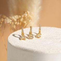 Celebrate your friend the way they deserve with our custom dangling Initial Huggie Earrings. These Pave diamond earrings are a personalized and meaningful gift for a birthday or even just to say, “Thinking of You”. Material: High Quality Solid 925 Sterling Silver Finish: 18K Gold Hoop Dimensions: ~8.5mm Inner Diameter | 12.5mm Outer Diameter Featuring ~7mm Pave Initial Charm Earrings Sold as a Pair SKU: RR-ER291 Pave Diamond Earrings, Gold C, Gold N, Huggie Earrings, Gold Letters, Initial Charm, Gold Hoop, Huggies Earrings, Charm Earrings