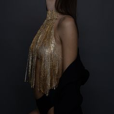 Turn heads and make a statement with our stunning Gold Crystal Chain Halter Top. This exquisite piece of evening wear is designed to dazzle and impress, perfect for special occasions, glamorous nights out, or any event where you want to shine. Premium Quality: Crafted from high-quality materials, this halter top features intricately linked gold chains adorned with sparkling crystals. Unique Design: The backless design with delicate chain details adds a touch of elegance and sophistication, ensur Elegant Embellished Body Jewelry For Parties, Glamorous Party Jewelry With Chain Detail, Glamorous Party Jewelry With Chain, Opulent Gold Necklaces For Evening, Opulent Gold Evening Necklaces, Opulent Gold Necklace For Evening, Opulent Gold Evening Necklace, Luxury Rhinestone Necklaces For Parties, Glamorous Silver Body Chain For Party