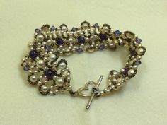 Swarovski Pearls, Bicones and Amethyst gemstones are the main components for this beautiful beaded bracelet.  A Sterling silver toggle clasp was used for closure.  Glass bronze seed beads enhance the charm of the bracelet. Elegant Purple Crystal Bracelet With Spacer Beads, Formal Beaded Crystal Bracelet With Round Beads, Handmade Beaded Bracelets For Anniversary, Formal Beaded Crystal Bracelet, Elegant Purple Beaded Crystal Bracelet, Handmade Elegant Amethyst Crystal Bracelet, Beautiful Beaded Bracelet, Swarovski Pearls, Toggle Clasp