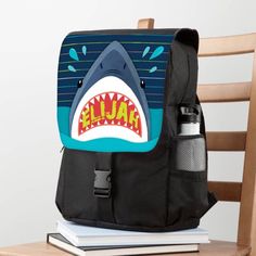 Featuring a spacious main compartment plus three zipper pockets of various sizes, this book bag has plenty of storage room. Includes separate holders for a cell phone, water bottle and pens. We'll add your little one's name to the inside the shark's mouth when you personalize! Size: 14 inch W x 20 inch H x 6 inch D. Gender: unisex. Age Group: adult. Shark Backpack, Shark Mouth, Phone Water, Flap Backpack, Personalized Backpack, A Cell, Storage Room, Book Bag, 6 D