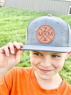 Personalized initial hats for the entire family! Choose any initial, number or symbol. See photos for examples!  These hats adjustable snapbacks are made of 100% cotton/polyester blend and feature vegan leather patches. Customization: In the personalization box please enter patch color and the combination of 4 letters, numbers and/or symbols you would like on the hat starting with the left quadrant and going clockwise (left, top, right, bottom). See pictures for list of available symbols.  If you'd like a symbol not listed simply send us a message!  For example: "Rawhide / G, R, H, Anchor" Sizing: On average our hats will fit the age ranges listed below utilizing the adjustable snapback for a comfortable fit - of course fit can vary on either end of this range due to differences in head si Personalized Casual Snapback Hat With Flat Bill, Snapback Hat With Letter Patch And Curved Brim, Personalized Flat Bill Hats For Outdoors, Personalized Flat Bill Hats For Outdoor, Adjustable Fitted Cap With Letter Patch, Customizable Adjustable Flat Bill Fitted Hat, Customizable Flat Brim Snapback Hat, Adjustable Flat Bill Baseball Cap, Snapback Hat With Letter Patch And Curved Bill