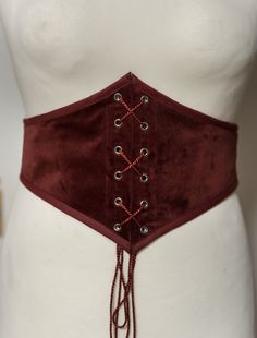 Do you like corsets but also like to feel comfortable in your clothes? This belt is made for you! This is an elastic waist cincher, made of quality red velvet. Steel stays on the front of the belt provide support and give the illusion that it is a real corset. The robust elastic that makes up the back of this accessory allows greater sheathing than a classic belt and will adapt perfectly to your size. Possibility to choose this model with braid or only with a cotton border. Item handmade in Fran Fitted Festival Corset With Belt, Elegant Red Corset Belt For Party, Elegant Red Fitted Corset Belt, Fitted Corset Belt For Costume, Victorian Corset, Velvet Corset, Classic Belt, Red Corset, Corset Belt