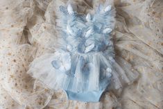 This is a listing for a romper/dress decorated with tulle ruffles with pearls and butterflies.  Sizes: The size is pretty flexible, it ties on the waist back area and it has an elastic.              6-9 month             9-18 month              Made to order (3-5 business days) All used materials are new. All items are made with care in a smoke/pet free environment. I would like to invite you to Your Dream Pix LLC VIP customers group!  Please, join us for all news and updates from my shop, new p Whimsical Ruffled Tutu Dress For Spring, Whimsical Ruffled Tutu Dress For Summer, Whimsical Summer Tutu Dress With Ruffles, Whimsical Ruffled Tutu Dress For Wedding, Blue Fitted Bubble Romper For Spring, Cute Fitted Bubble Romper For Baptism, Fitted Blue Bubble Romper For Spring, Spring Fitted Blue Bubble Romper, Cute Tutu Dress For Baptism In Summer