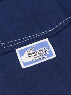 Story Mfg.'s '555' overshirt has been hand-dyed in fermented indigo pits for several days to achieve its deep colour. It's tailored from organic cotton-twill in a workwear silhouette that's both neat and practical. The imperfect topstitching is an ode to vintage single-needle machinery. Lower Impact Materials. This product is made using at least 50% lower-impact materials or ingredients. Responsible Craftsmanship. This product promotes artisanal skill and brands that invest in communities and a… Cute Clothing Labels, Clothing Label Ideas, Indigo Button-up Utility Outerwear, Selvedge Denim Blue Cotton Jacket, Vintage Selvedge Denim Blue Outerwear, Kapital Century Denim, Cotton Twill Jacket, Vintage Indigo Pre-washed Outerwear, Shirt Jacket Men