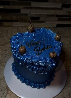 a blue birthday cake with gold decorations and writing on the top that says vegas buddha