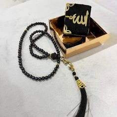 Discover our Elegant Islamic Gift Set Designed for spirituality and sophistication, it's perfect for any occasion. This set includes a mini Qur'an and beautifully crafted Rosary (prayer beads) for a meaningful connection with faith. Versatile for weddings, birthdays, Eid, Ramadan, Mawlid, or to simply show your love and respect. With a stylish black design and luxurious presentation, it's a thoughtful gift, especially for Muslim women. Although the entire Quran is written, the small print is not Adjustable Spiritual Rosary As Gift, Black Rosary With 108 Beads As Gift, Adjustable Rosary With 108 Beads As Gift, Elegant Beaded Rosary For Gift, Elegant Beaded Rosary As Gift, Traditional Black Rosary As Gift, Elegant Black Rosary As Gift, Islamic Wedding Gifts, Mini Quran