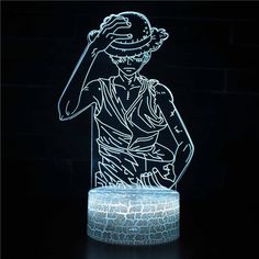 an illuminated sculpture of a man with a hat on his head