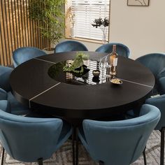 a round table with blue chairs around it