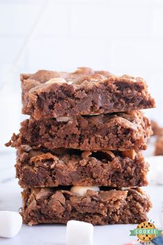 three brownies stacked on top of each other with marshmallows