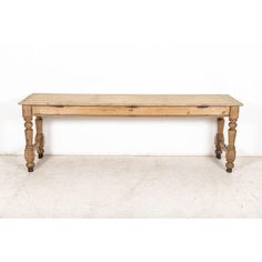 a wooden bench sitting on top of a white floor