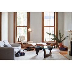 a living room filled with furniture and windows