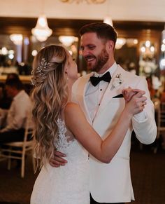 a bride and groom dance together at their wedding reception