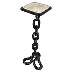 a black and white table with chains attached to the top, on a white background