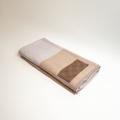 a folded blanket sitting on top of a white table