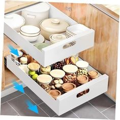 an open drawer in a kitchen filled with containers and food items on the bottom shelf